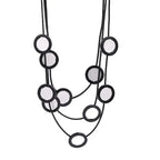 Elegant black multi-layered necklace with circular mirror accents. A bold statement piece for women’s fashion jewelry