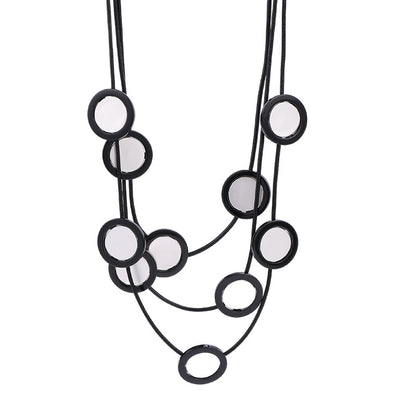 Elegant black multi-layered necklace with circular mirror accents. A bold statement piece for women’s fashion jewelry