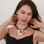 Gold plated statement necklace with large flower pendant