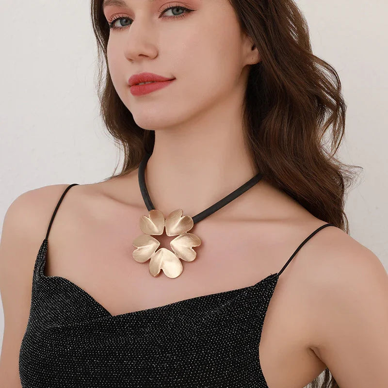 Gold plated statement necklace with large flower pendant