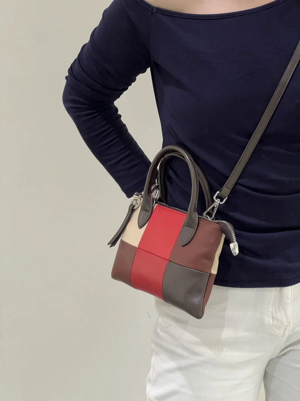 Colorblock leather purse with yellow, blue, and grey panels