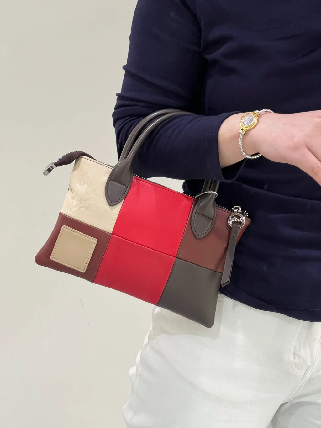 Colorblock leather purse with yellow, blue, and grey panels