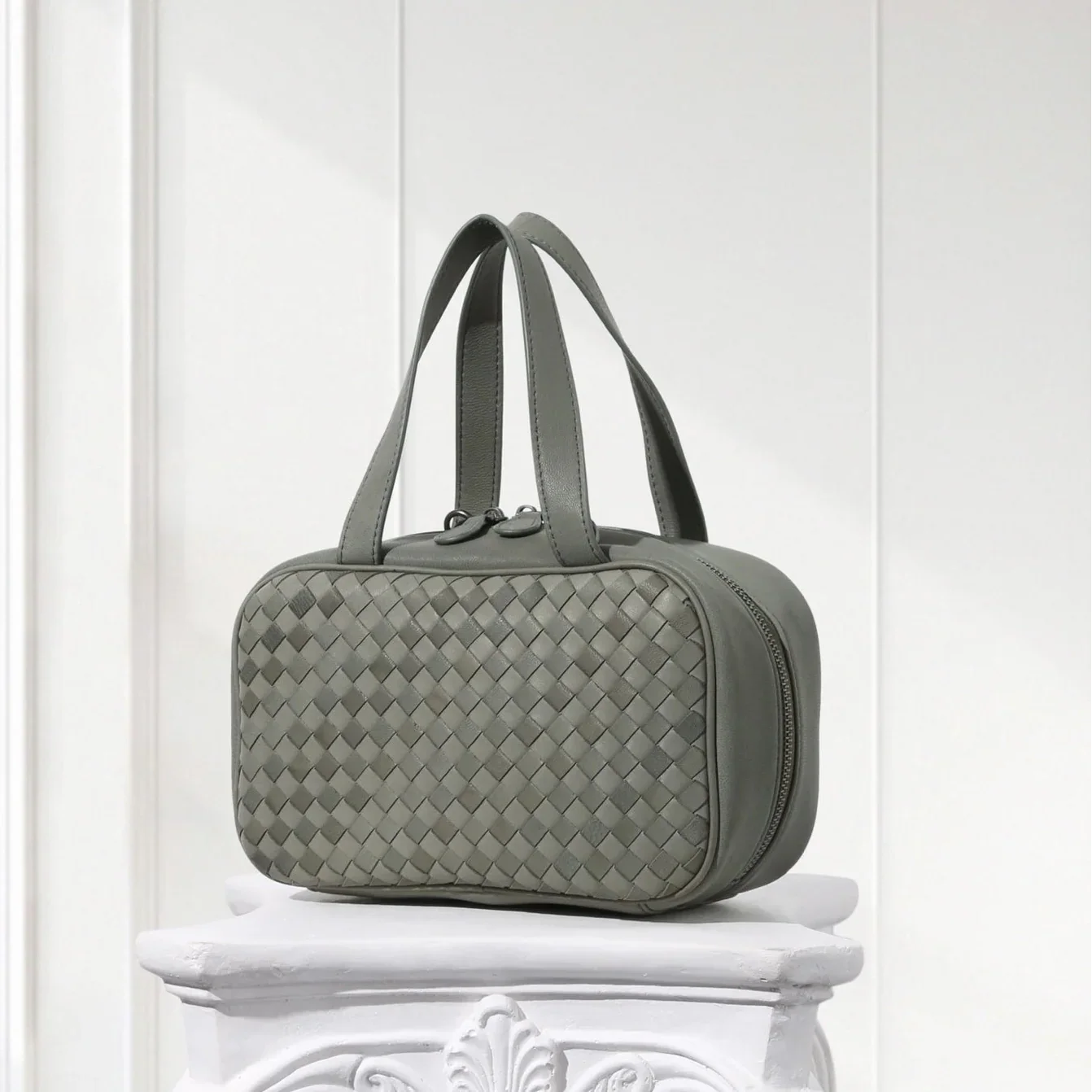 Handcrafted hunter green leather woven tote displayed on table – minimalist box purse