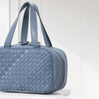 Blue handcrafted braided leather tote bag displayed on white background – luxury box purse