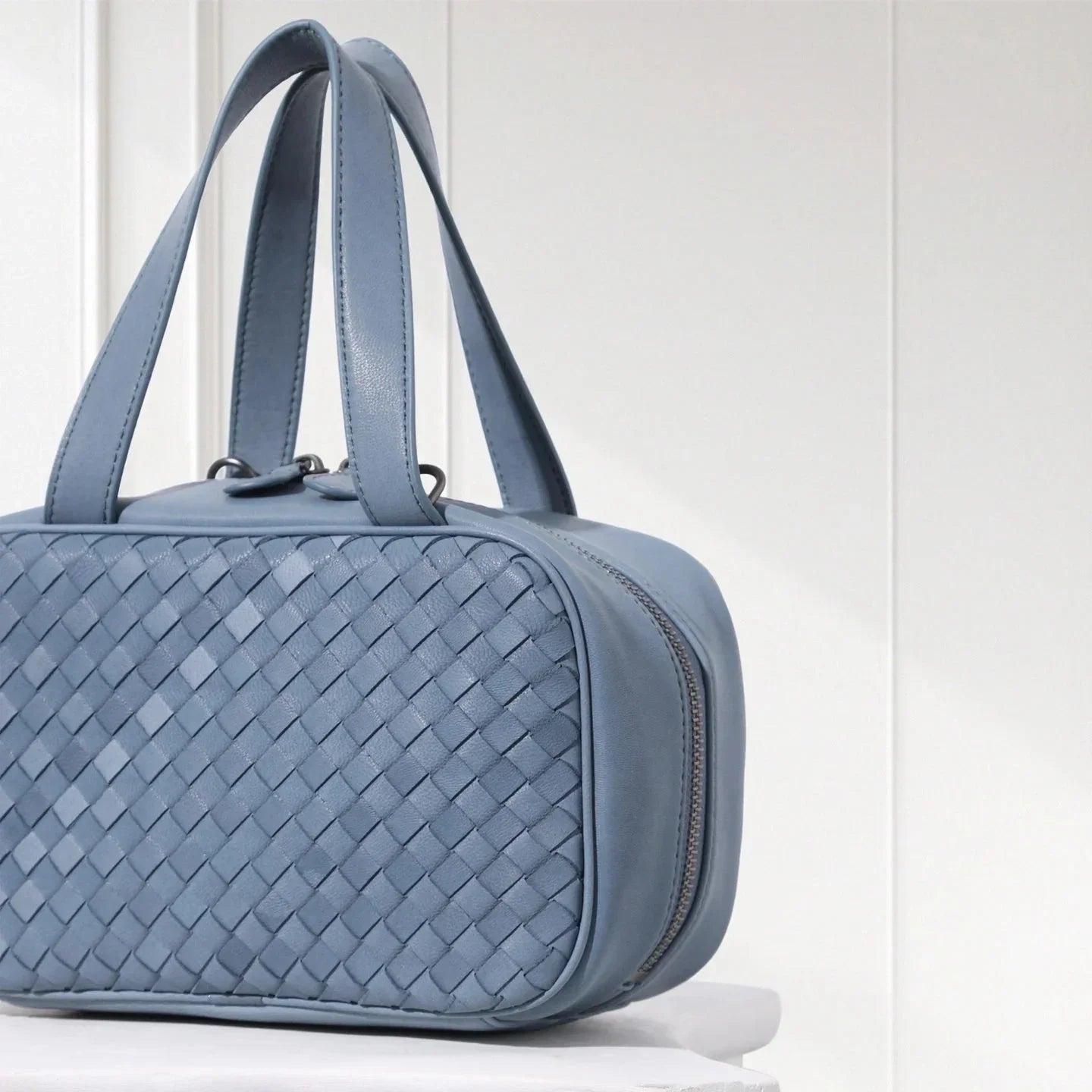 Blue handcrafted braided leather tote bag displayed on white background – luxury box purse