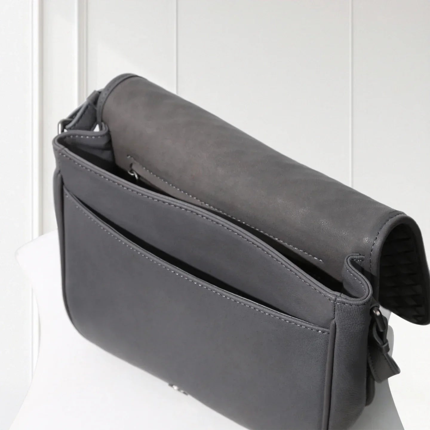 Gray leather shoulder bag on a white background
