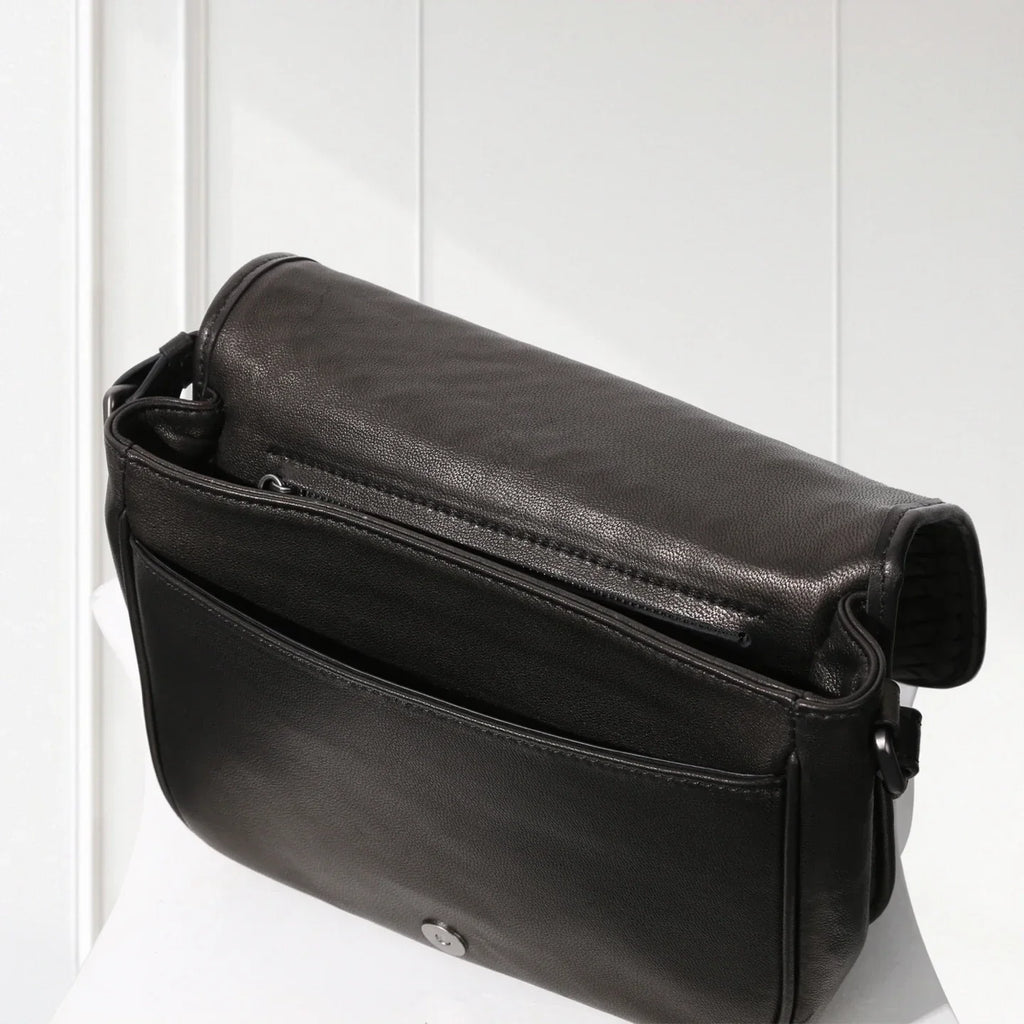 Black leather shoulder bag on a white background