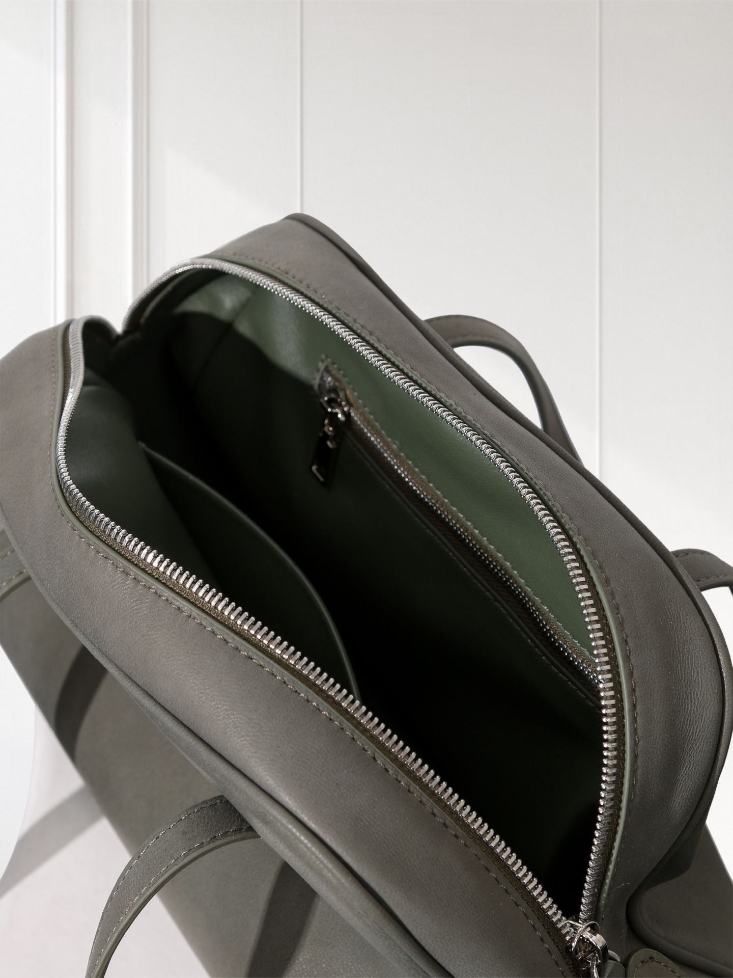 Gray backpack with a zipper on a white background