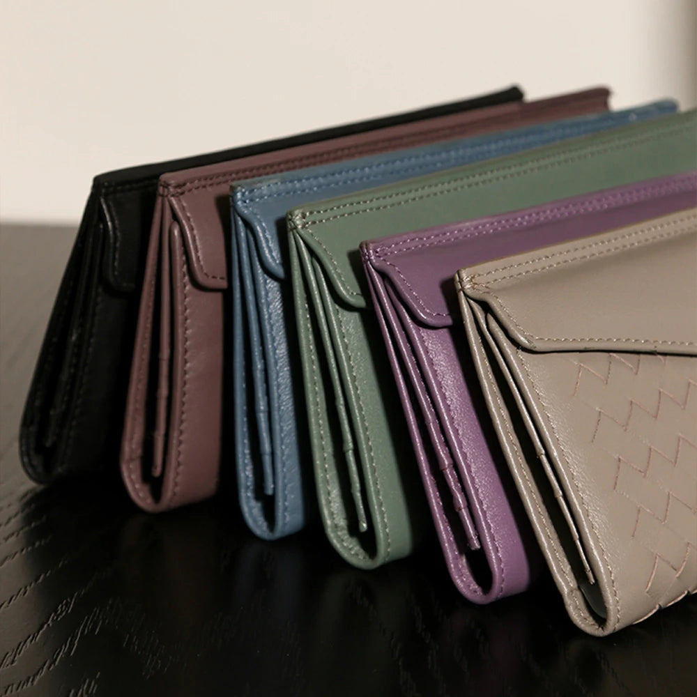 Experience the buttery softness of our Artisanal Sheepskin Woven Wallet. A slim bifold design featuring a secure coin purse and bill storage.