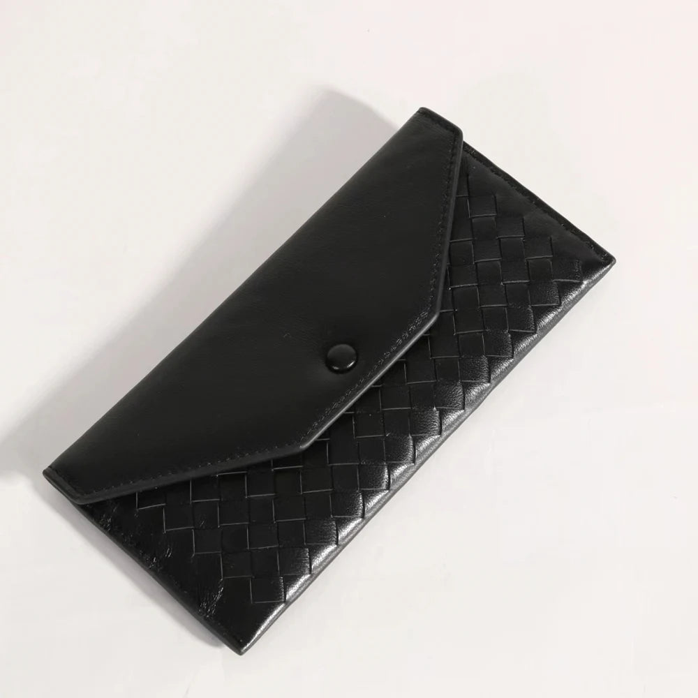 Black woven clutch bag on a light gray background