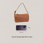 Brown woven handbag next to an Apple iPhone 16 pro on a light gray background