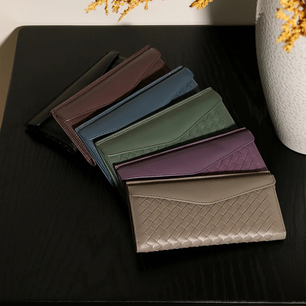 Experience the buttery softness of our Artisanal Sheepskin Woven Wallet. A slim bifold design featuring a secure coin purse and bill storage.