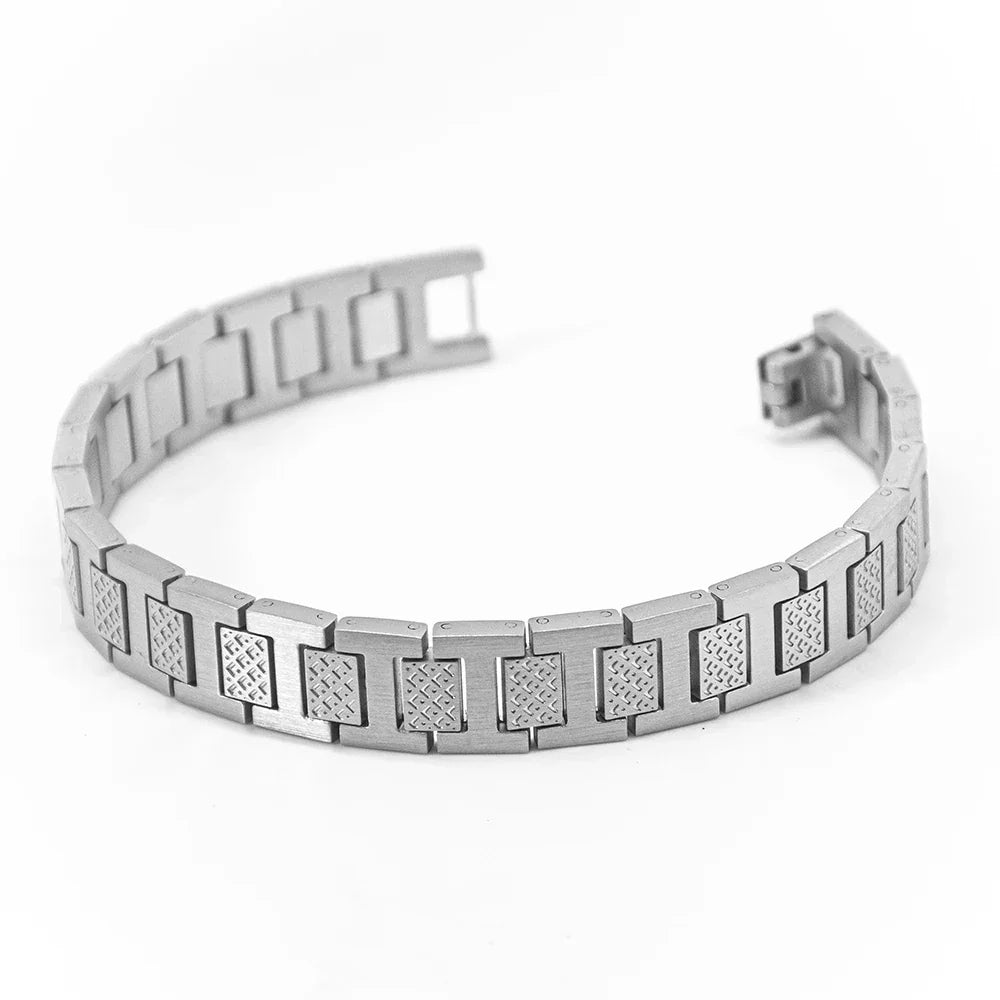 Silver bracelet with diamond-like inlays on a white background