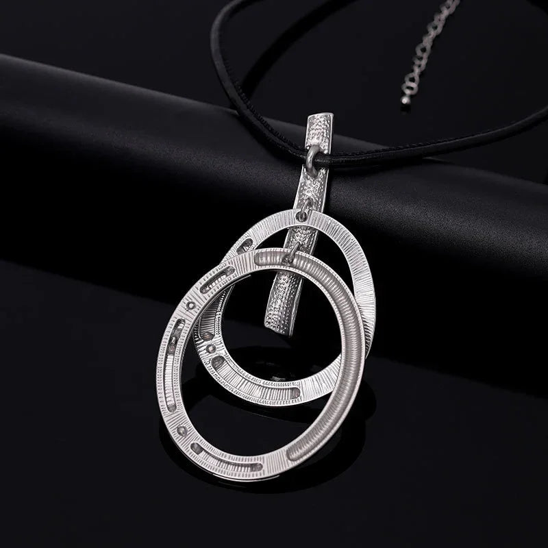Woman wearing modern interlocking silver pendant necklace, minimalist contemporary jewelry | Civibuy wholesale USA