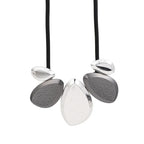 Textured and polished silver teardrop pendants on black rubber cord, geometric statement necklace | Shop Civibuy near New York