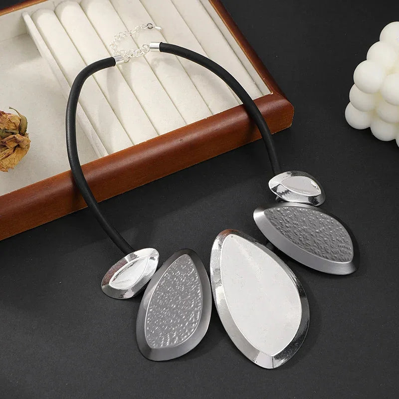 Woman wearing modern geometric silver statement necklace, bold contemporary jewelry | Civibuy wholesale USA