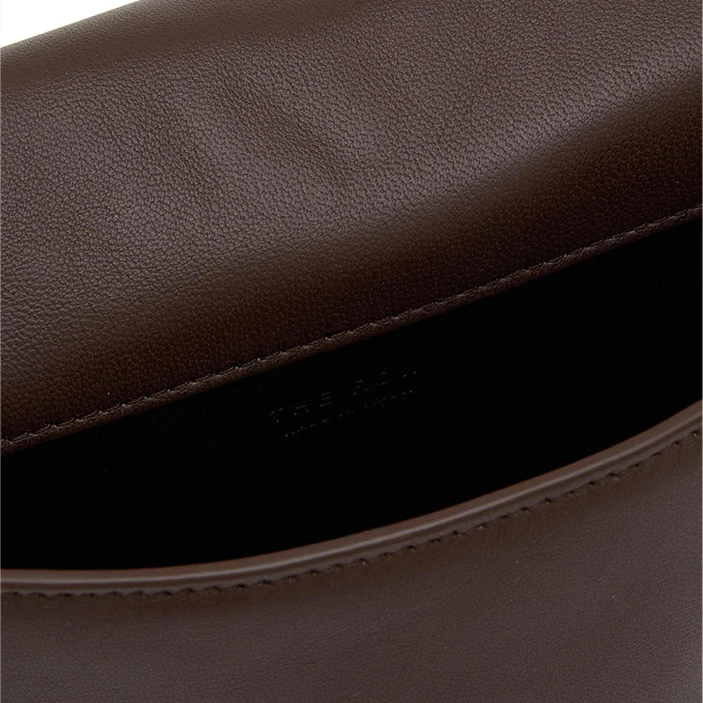 Minimalist dark brown lambskin messenger bag with front flap, adjustable shoulder strap, and slim rectangular design for women.