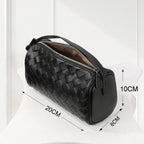 Side view of elegant black woven leather handbag, handcrafted weave design with smooth finish.