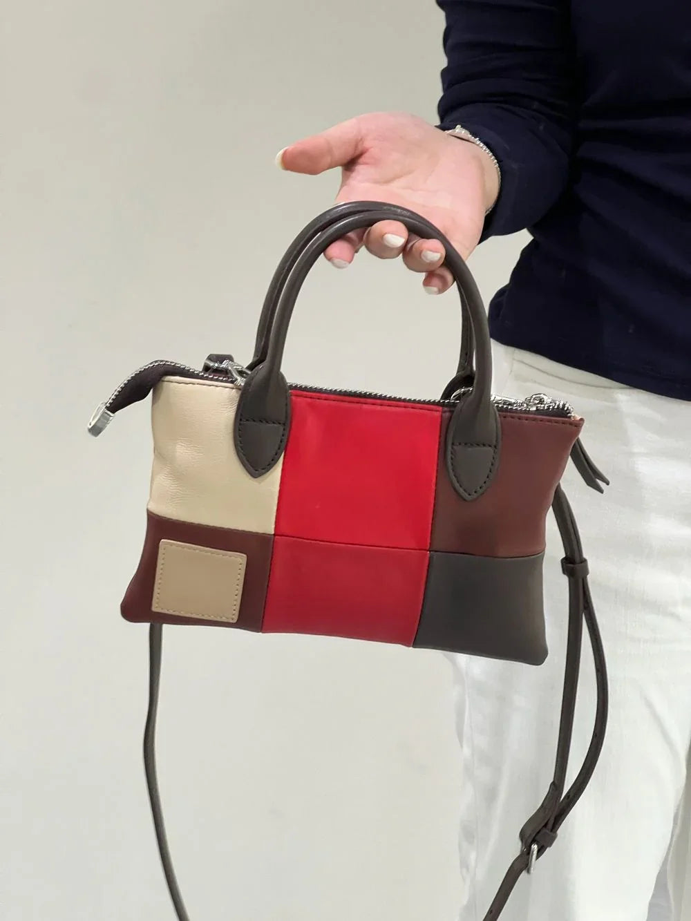 Colorblock leather purse with yellow, blue, and grey panels