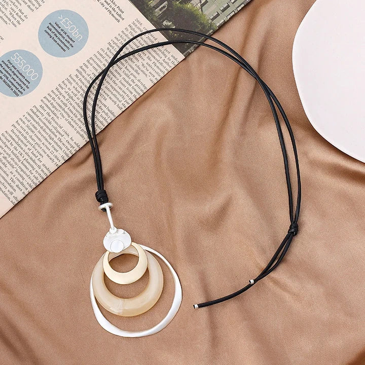 Necklace with a unique pendant on a brown surface