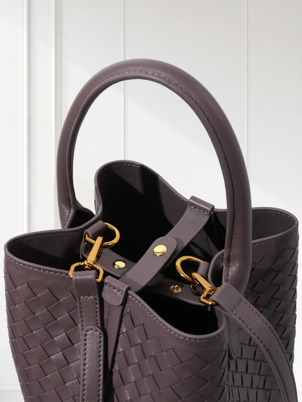 Handcrafted brown woven leather bucket tote with green suede inner bag, 100% lambskin