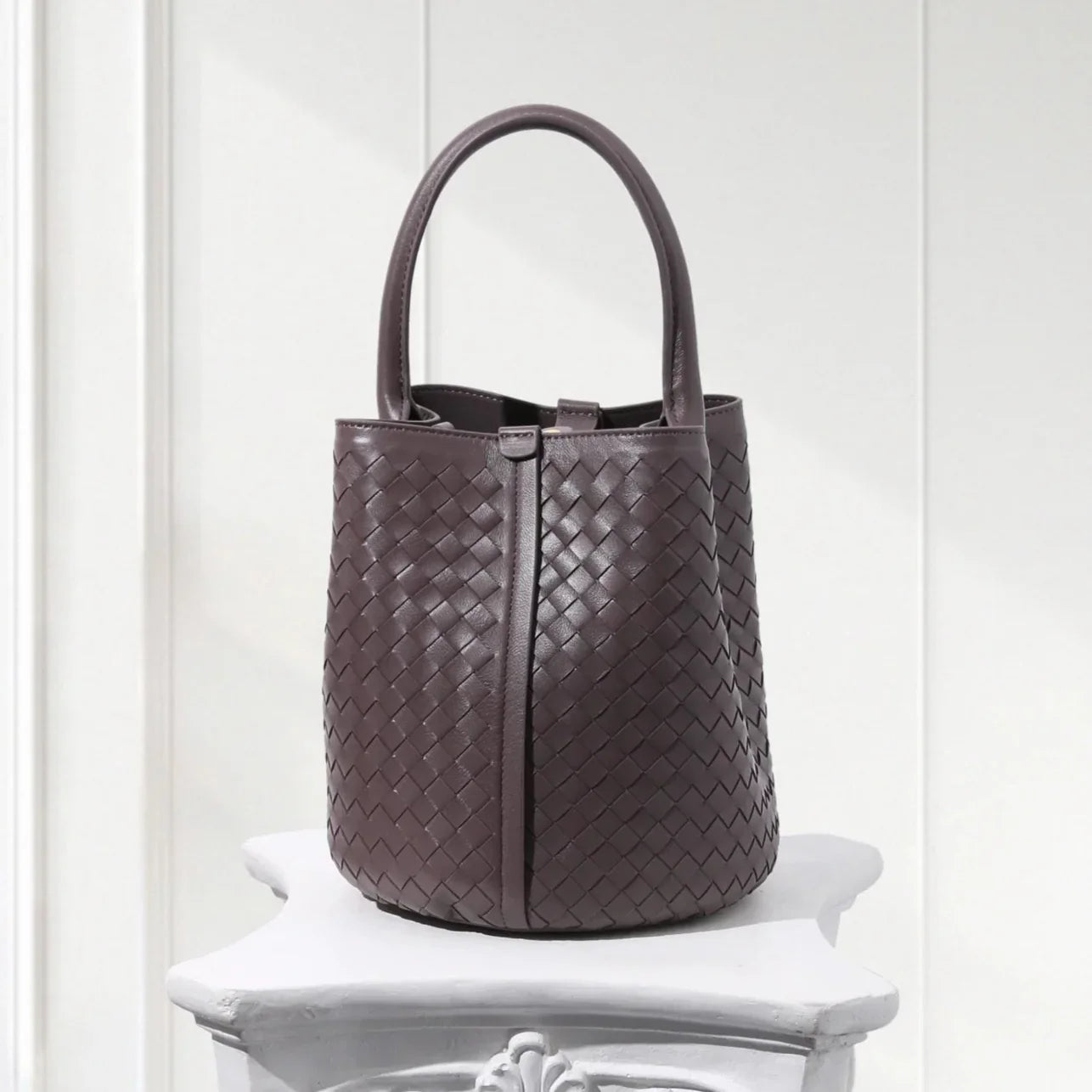 Handcrafted brown woven leather bucket tote with green suede inner bag, 100% lambskin