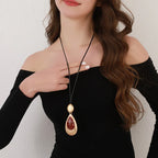Elegant Teardrop Pendant Necklace with Golden Accent & Red Gemstone