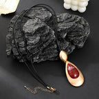 Elegant Teardrop Pendant Necklace with Golden Accent & Red Gemstone