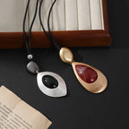 Elegant Teardrop Pendant Necklace with Golden Accent & Red Gemstone