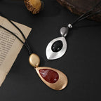 Elegant Teardrop Pendant Necklace with Golden Accent & Red Gemstone