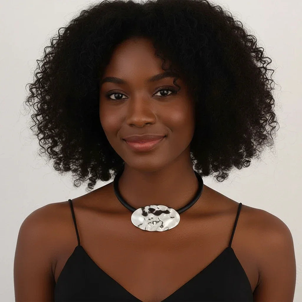 Textured silver oval pendant on black rubber cord, abstract modern jewelry design | Shop Civibuy near New York