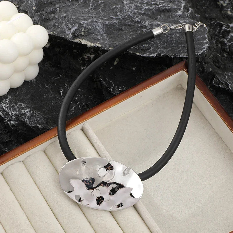 Modern Abstract Silver Oval Pendant Necklace – minimalist silver jewelry with black rubber cord | Civibuy wholesale near New York