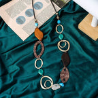 Necklace with various beads on a green fabric surface Wholesale available near CA, US on Civibuy.com.