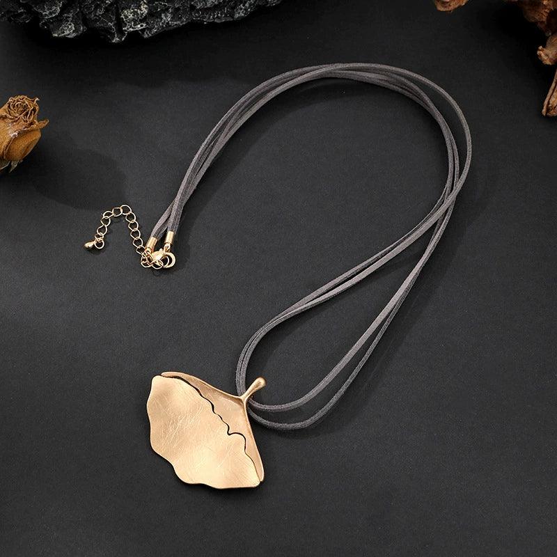 Gold leaf pendant necklace on leather cord – stylish autumn winter fashion jewelry, wholesale available near Clearwater FL