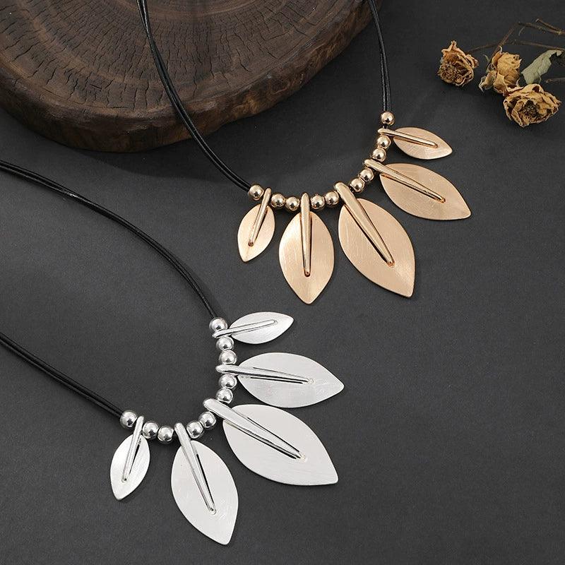 Necklace with leaf-shaped pendants on a dark surface