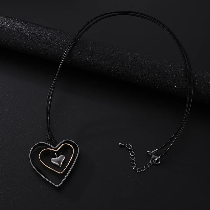 Necklace with heart-shaped pendant on a black background