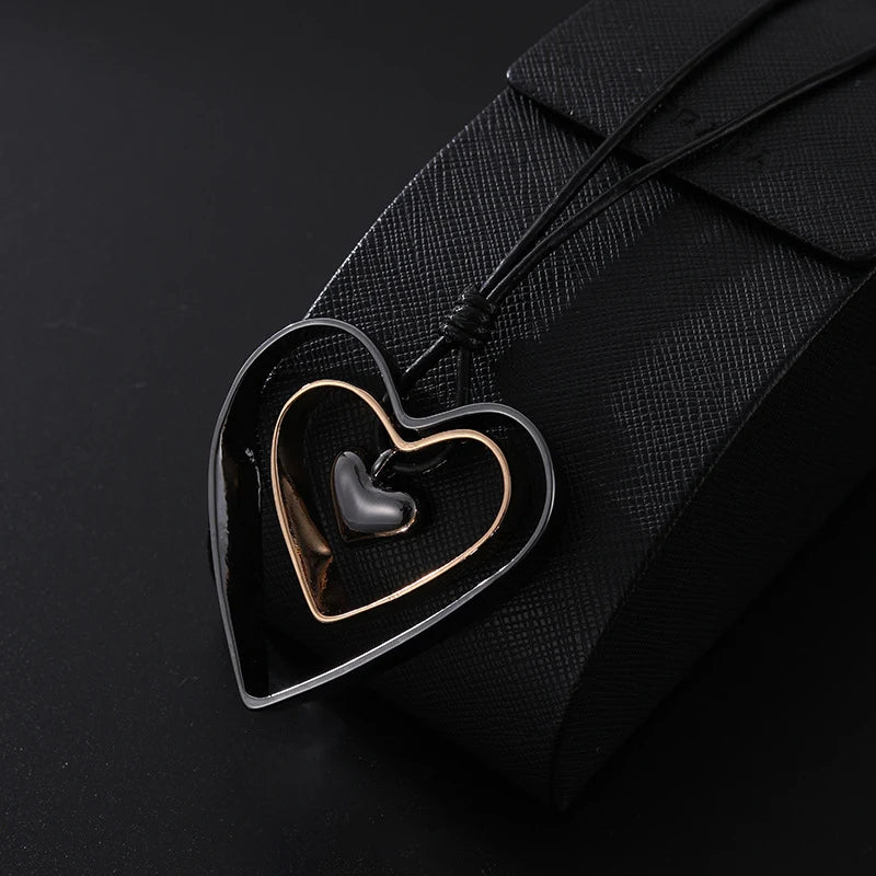 Heart-shaped pendant with a black interior on a black background