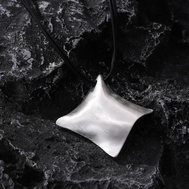 Silver pendant on a dark textured background