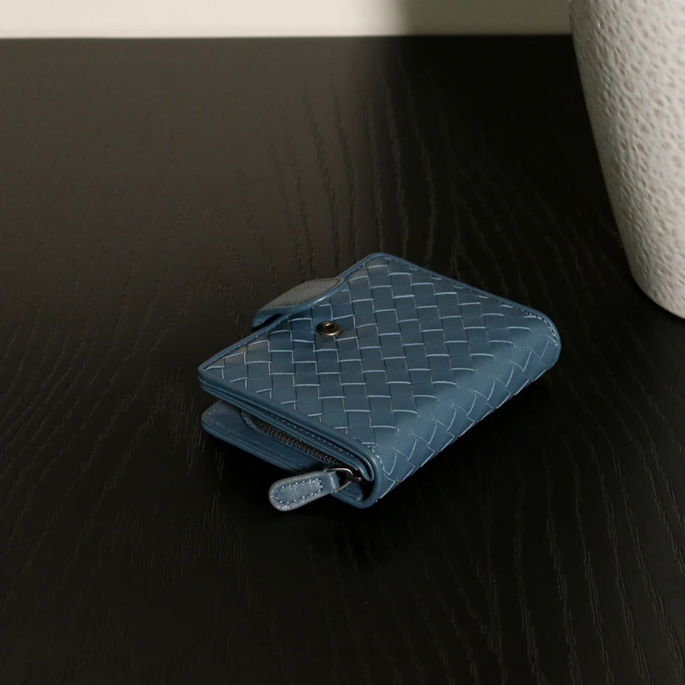 Handcrafted Nappa leather woven wallet in a rich earthy red-brown hue, showing a compact bi-fold design and premium textured