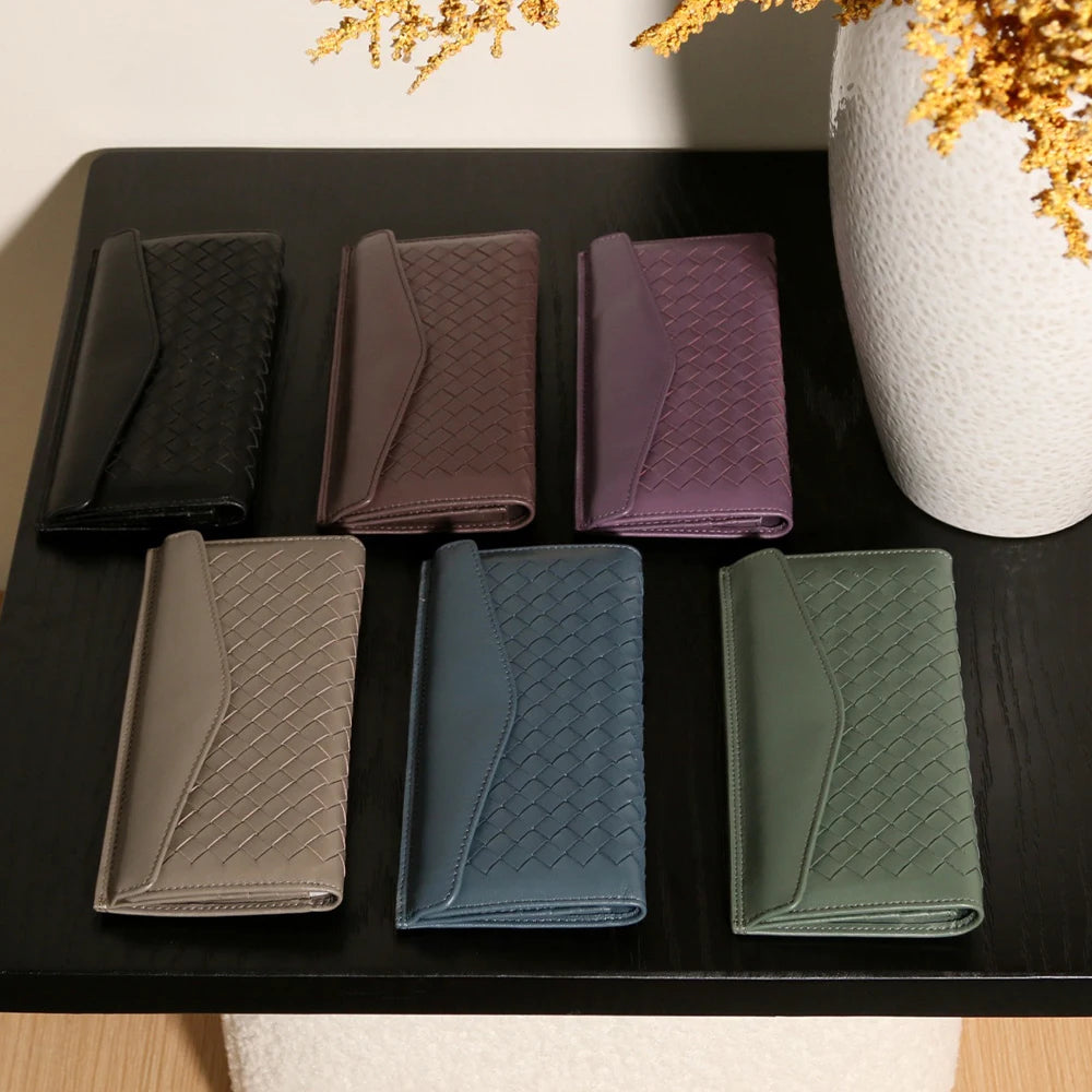 Experience the buttery softness of our Artisanal Sheepskin Woven Wallet. A slim bifold design featuring a secure coin purse and bill storage.