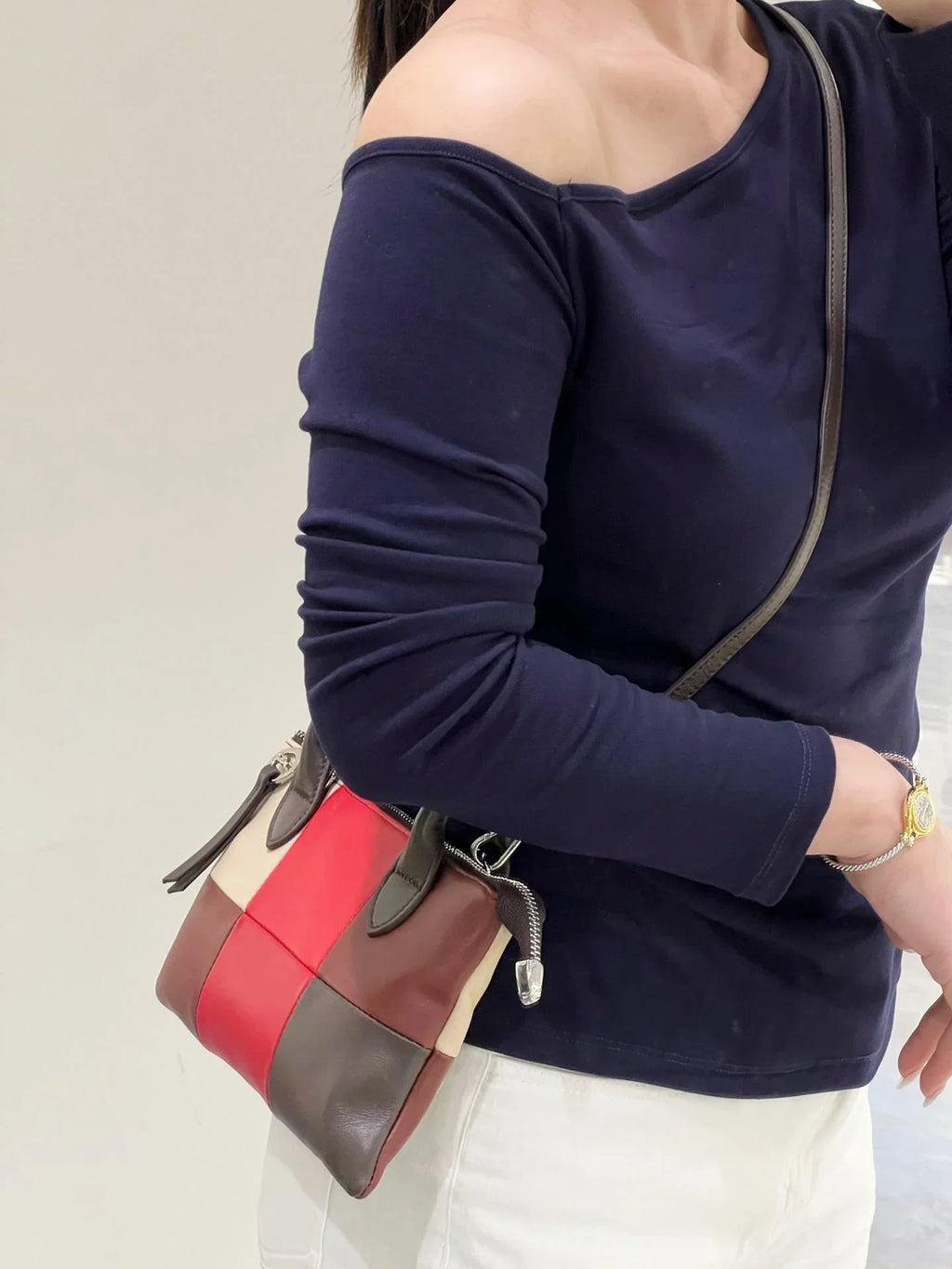 Colorblock leather purse with yellow, blue, and grey panels