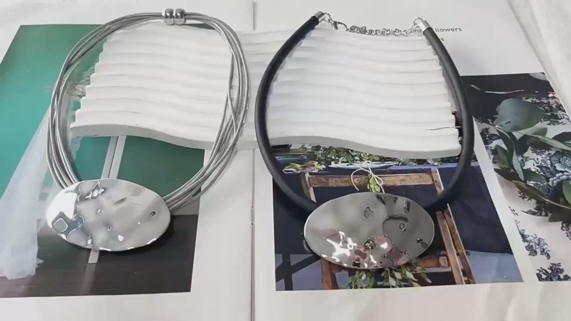 Textured silver oval pendant on black rubber cord, abstract modern jewelry design | Shop Civibuy near New York