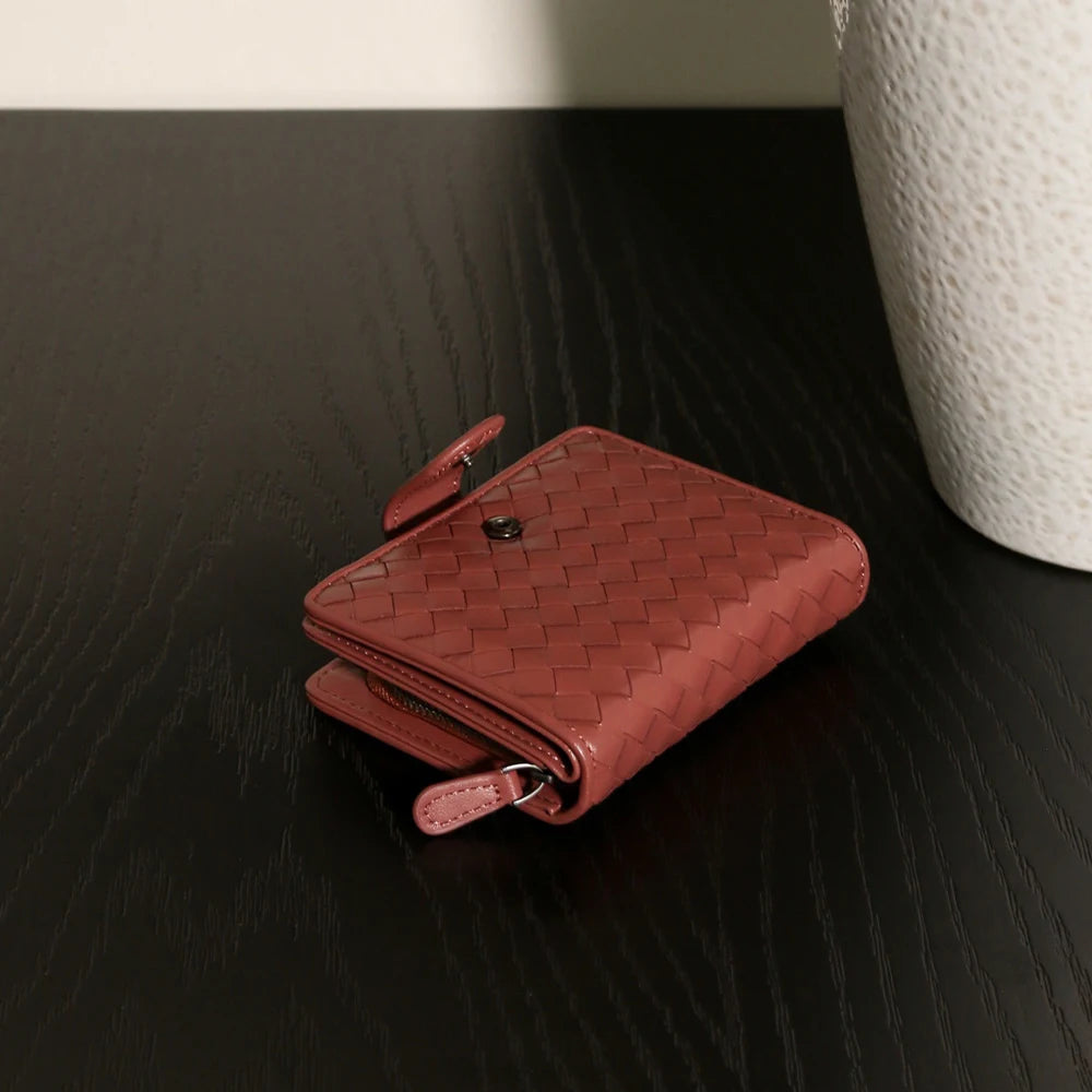 Handcrafted Nappa leather woven wallet in a rich earthy red-brown hue, showing a compact bi-fold design and premium textured