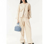 Woman holding blue woven leather handbag – elegant handmade purse for daily use