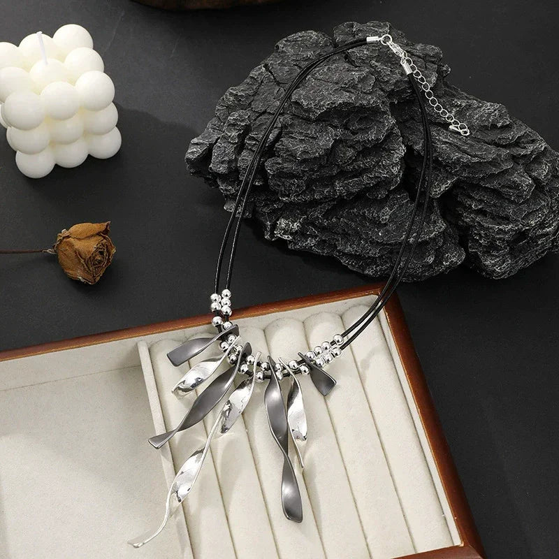 Women’s silver and black statement necklace with leather cord and unique pendant design